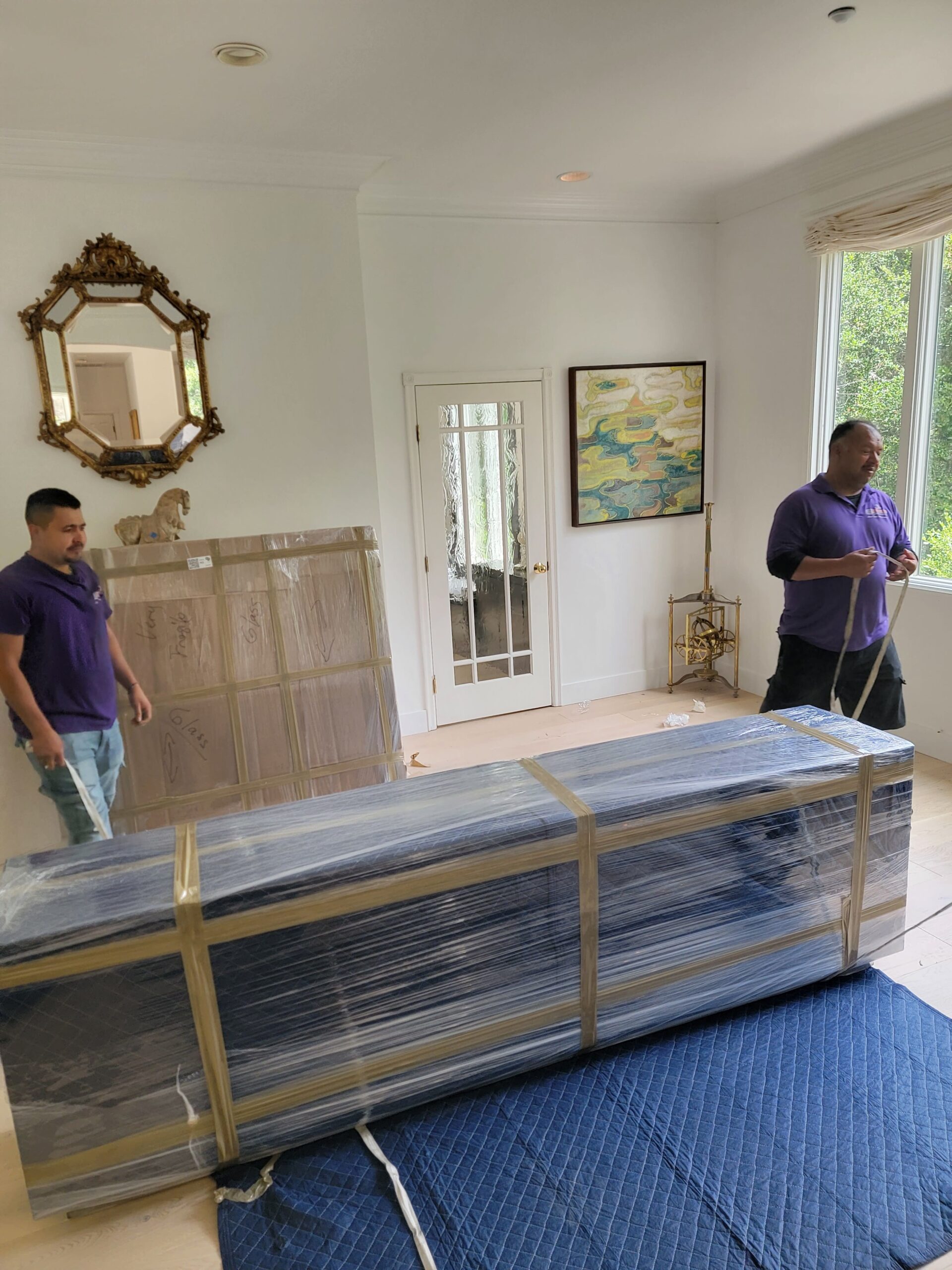 Home staging movers arranging furniture for a property listing